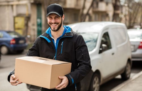 74990904 – delivery man with cap and cardboard in hands 74990904 - delivery man with cap and cardboard in hands